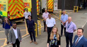 Group of visitors including Lord Kamall and Matt Whitty outside John Radcliffe Hospital