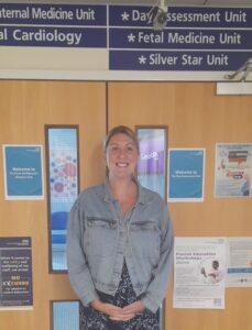 Hannah Stewart, pregnant volunteer, standing outside maternity ward