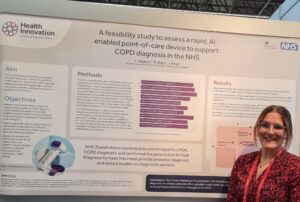 Lauren Hudson stands alongside her poster at ERS Congress