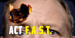 An image from the ACT F.A.S.T. campaign featuring the top half of a person's face with a small fire burning above one eye