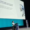Mamta Bajre presenting at RISE UK 2026. Her slide reads "robotic surgery is not a procurement project. It is a transformation programme."